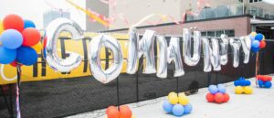 Community balloons on a fence